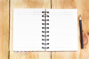 Note book and pencil on wooden background - vintage effect style