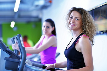 Group of people running on treadmills