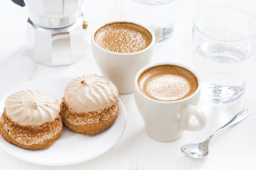 cup of fresh espresso and cakes for breakfast on white table