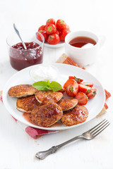 Delicious pancakes with fresh strawberries on a plate, jam