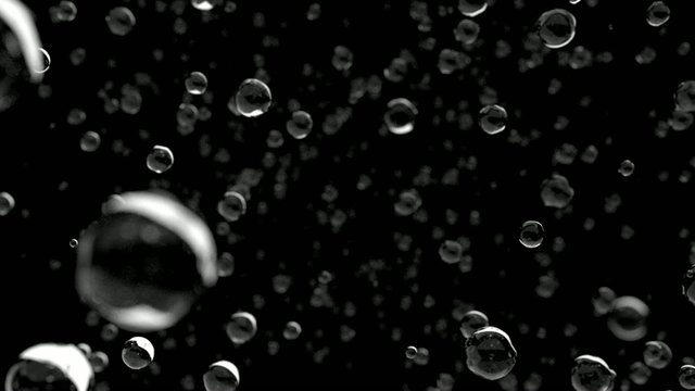 Rain water droplets close up falling away from camera DOF slow m