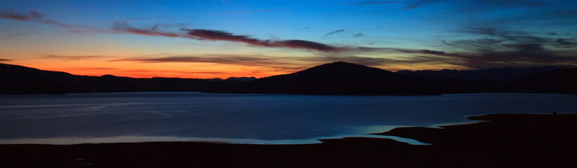 twilight panorama from high mountain lake, abstract nature background 
