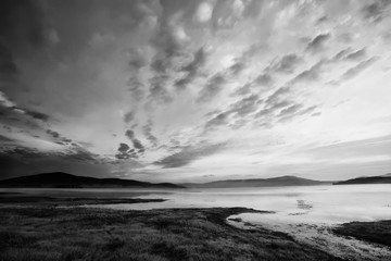 Fototapeta na wymiar black and white landscape with dramatic sky over the high mountain lake 