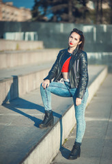 Fototapeta premium Young fashion hipster beautiful girl in leather jacket outdoor