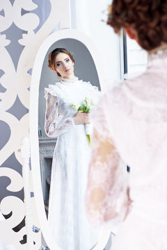 Spring bride dress in vintage style with a bouquet of tulips