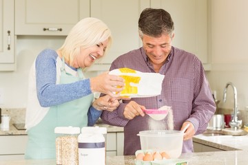 Happy mature couple baking together