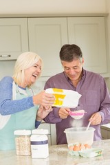 Happy mature couple baking together