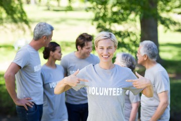 Happy volunteer blonde smiling at the camera
