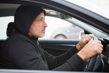 Thief breaking into a car