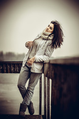 Pretty young girl outdoor on the old bridge