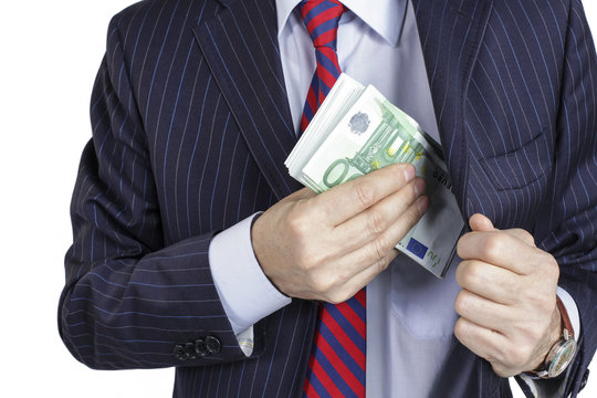 Businessman pocketing a bribe