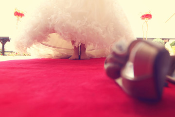 bride on red carpet with bare feet
