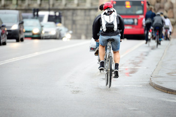 Naklejka na ściany i meble Bicycle on rainy city street