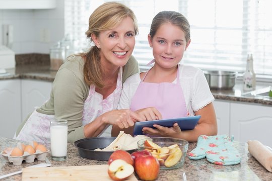 Happy mother and daughter preparing cake together