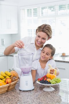 Mother And Daughter Making A Smoothie