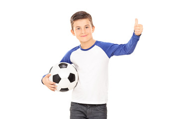 Boy holding a football and giving a thumb up