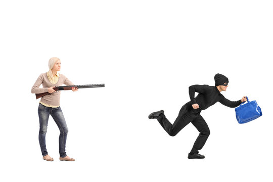 Angry woman chasing a burglar with a shotgun