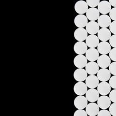 White pills on black