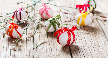.Easter eggs and branch with spring flowers