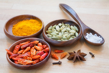 colorful spices in wooden bowls