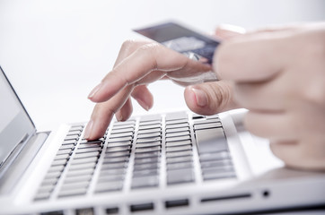 Female hands entering credit card information into a laptop