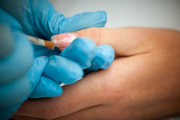 Making hand nails in a professional hand care salon - manicure