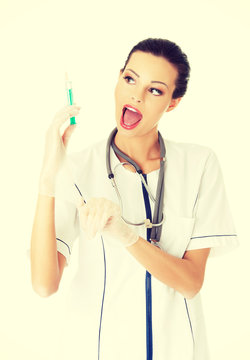 Smiling female doctor with a syringe.