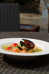 Image of tasty salmon soup with oysters in dish