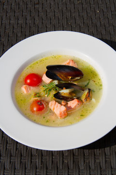 Image of tasty salmon soup with oysters in dish