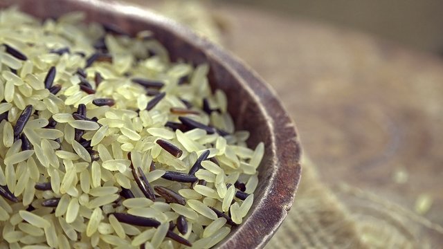 Portion of raw mixed Rice (seamless loopable 4K footage)