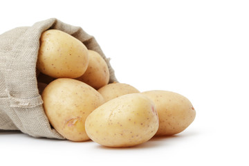 raw fresh potatoes in burlap bag white copy space