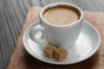 cup of freshly made espresso on wood board
