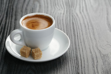 cup of freshly made espresso on wood board