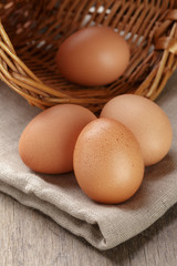 whole raw brown eggs closeup on wood table