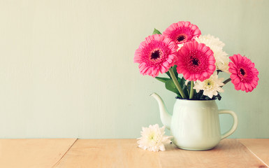 summer  bouquet of flowers on the wooden table with mint backgro