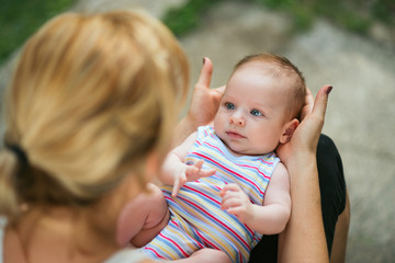 Loving mother holding baby in her lap