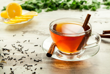 Glass cup of tea on a wooden table.
