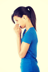 Woman blowing her nose.