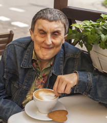 Disabled man with cerebral palsy sitting at cafe.