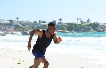 Fototapeta na wymiar Healthy young man running on the beach