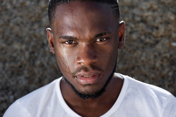 Young african american man with sweat dripping down face