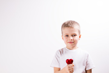 Young boy with red heart