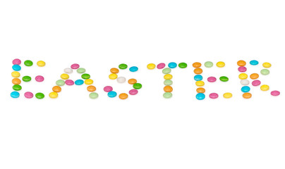 happy letters easter, colored candys isolated on white