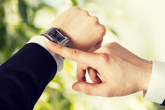 man looking at wristwatch