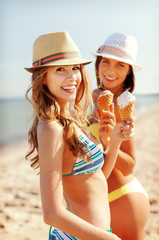 girls in bikinis with ice cream on the beach