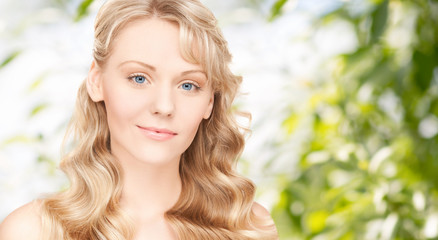 Naklejka premium beautiful young woman face with long wavy hair