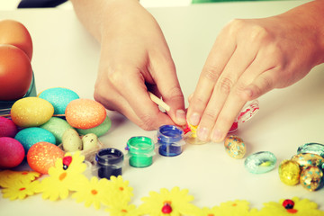 Young girl is making easter decoration