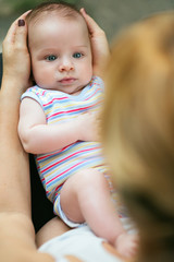 Loving mother with baby in her lap