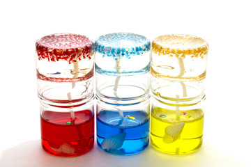 candles in glass on each other on a white background