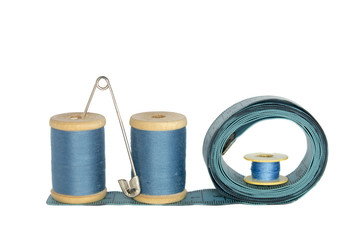 spools of thread with a ruler on a white background
